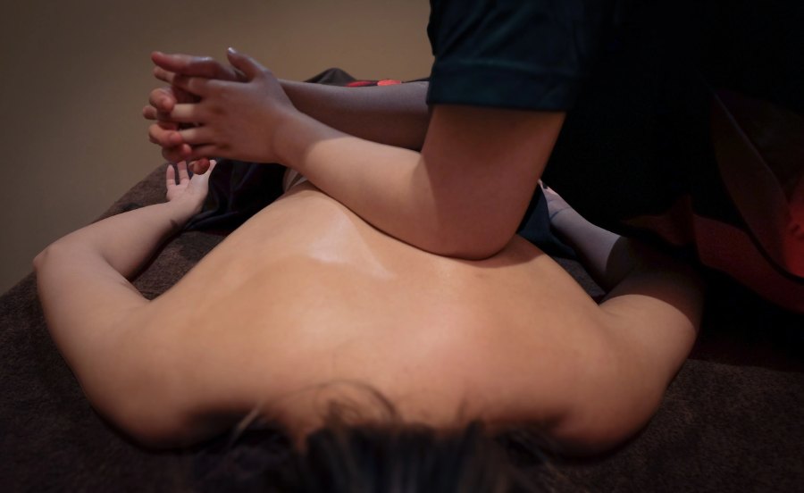 Therapist working on a client's back during a sports massage